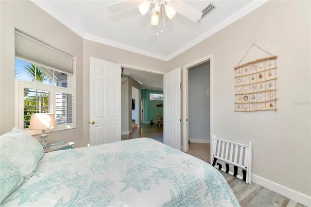 a bedroom with a bed and a chandelier