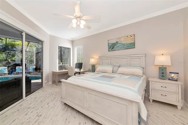 a spacious bedroom with a large bed and a chandelier