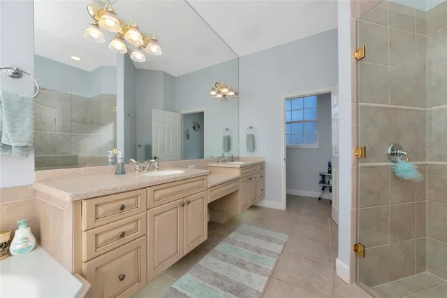 a bathroom with a double vanity sink a toilet and a mirror