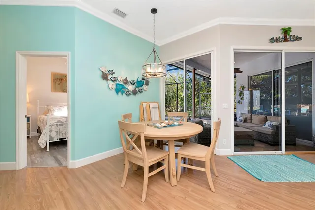 a dining room with furniture wooden floor a chandelier