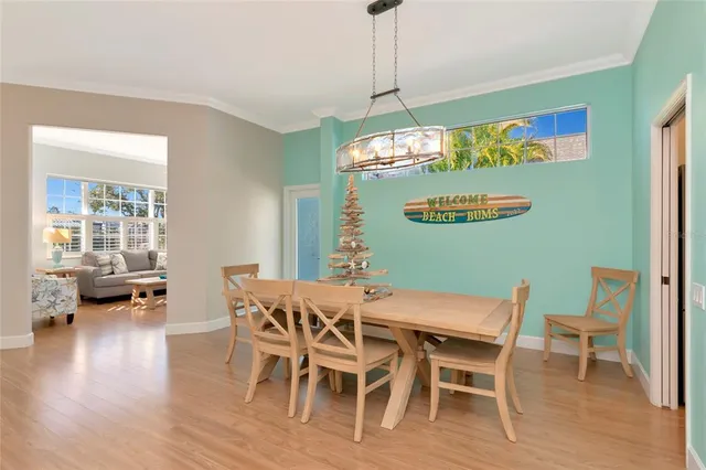 a view of a dining room with furniture wooden floor and chandelier