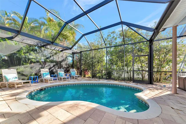 an aerial view of a house with a yard and sitting area