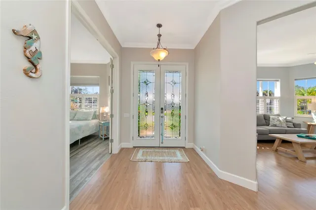 a view of a hallway view with wooden floor and living room