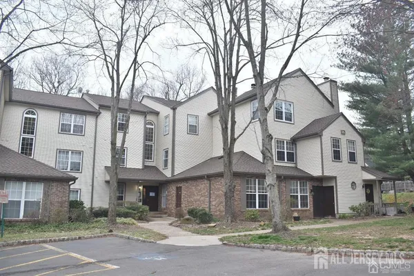 a kitchen with kitchen island a refrigerator and a stove top oven