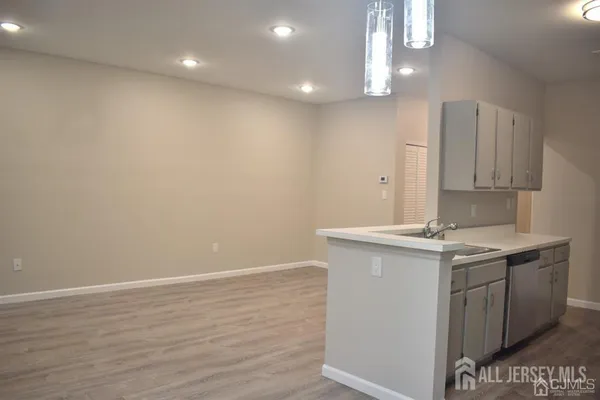 a view of an empty room with a fireplace and a window