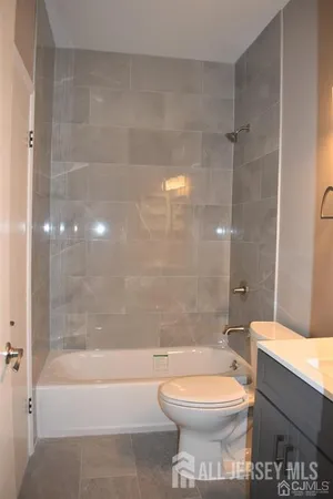 a bathroom with a toilet sink and shower