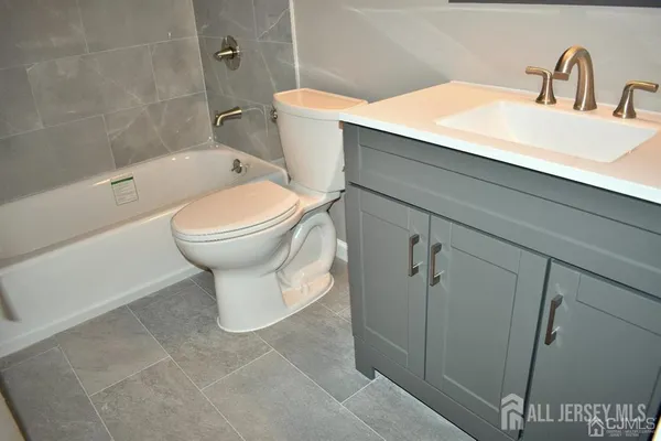 a kitchen with stainless steel appliances granite countertop a refrigerator and a stove