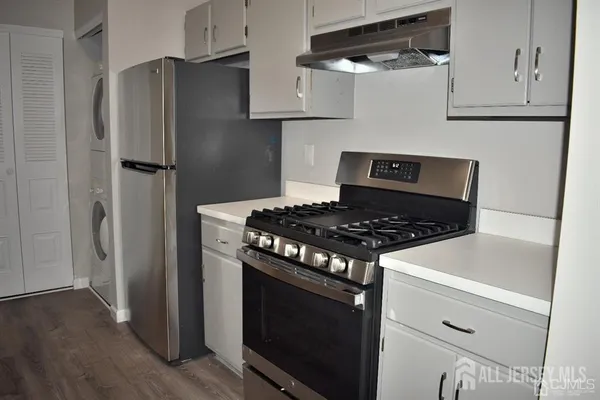 a kitchen with kitchen island a sink stove and refrigerator
