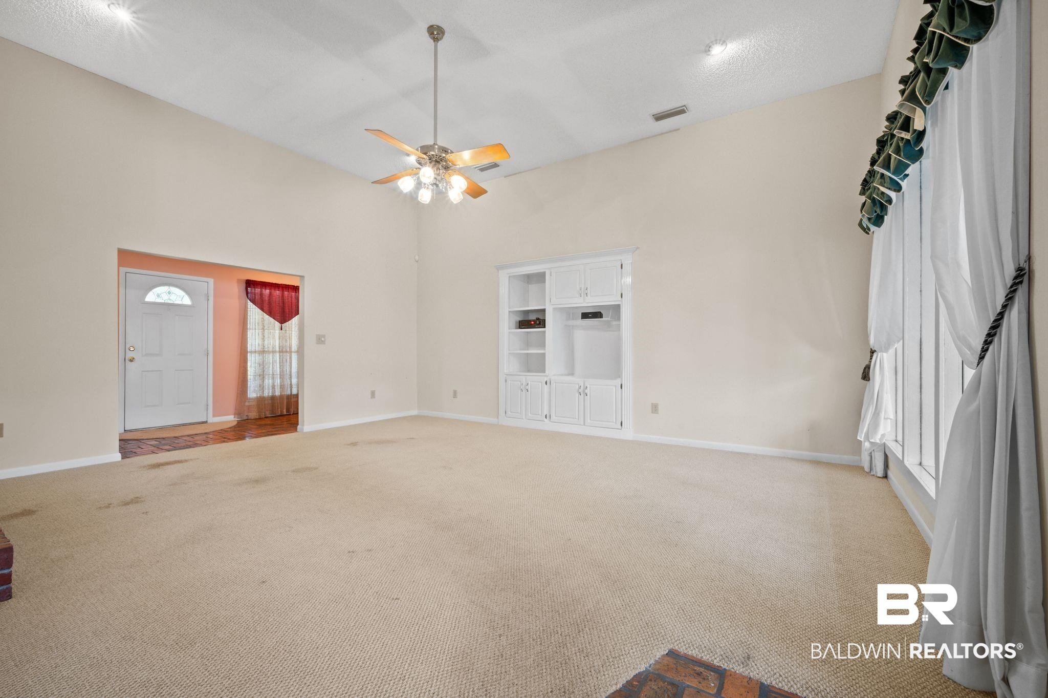 15801 Maytower Road Bay Minette, AL 36507 - Photo 8 of 43 Unfurnished living room with light colored carpet and ceiling fan