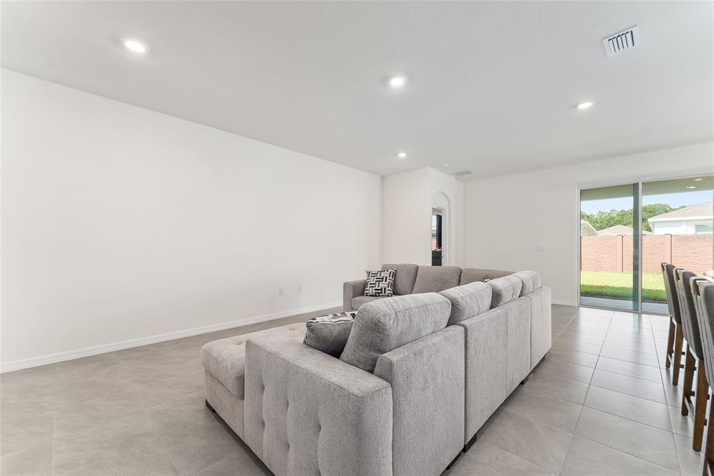 4098 Northwest 48th Terrace Ocala, FL 34482 - Photo 13 of 58 a living room with furniture and a floor to ceiling window
