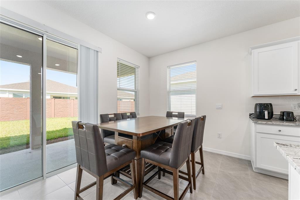 4098 Northwest 48th Terrace Ocala, FL 34482 - Photo 23 of 58 a view of a dining room with furniture and a potted plant
