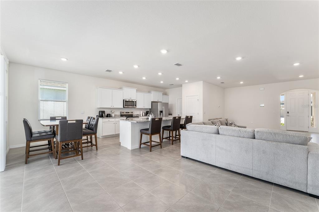 4098 Northwest 48th Terrace Ocala, FL 34482 - Photo 26 of 58 a living room with lots of furniture and kitchen view