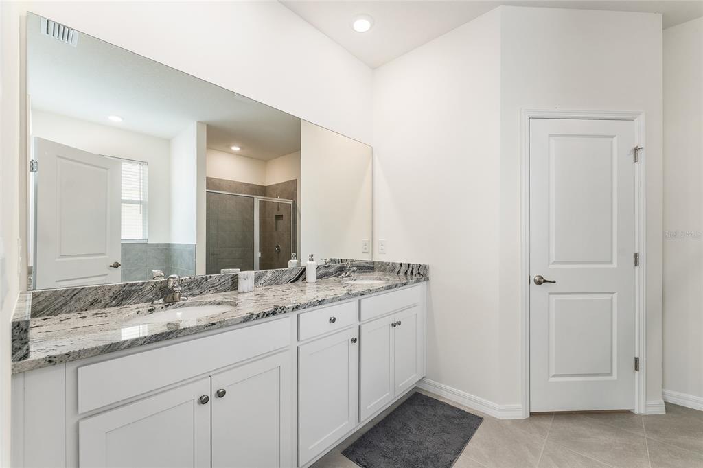 4098 Northwest 48th Terrace Ocala, FL 34482 - Photo 32 of 58 a bathroom with a granite countertop sink and a mirror