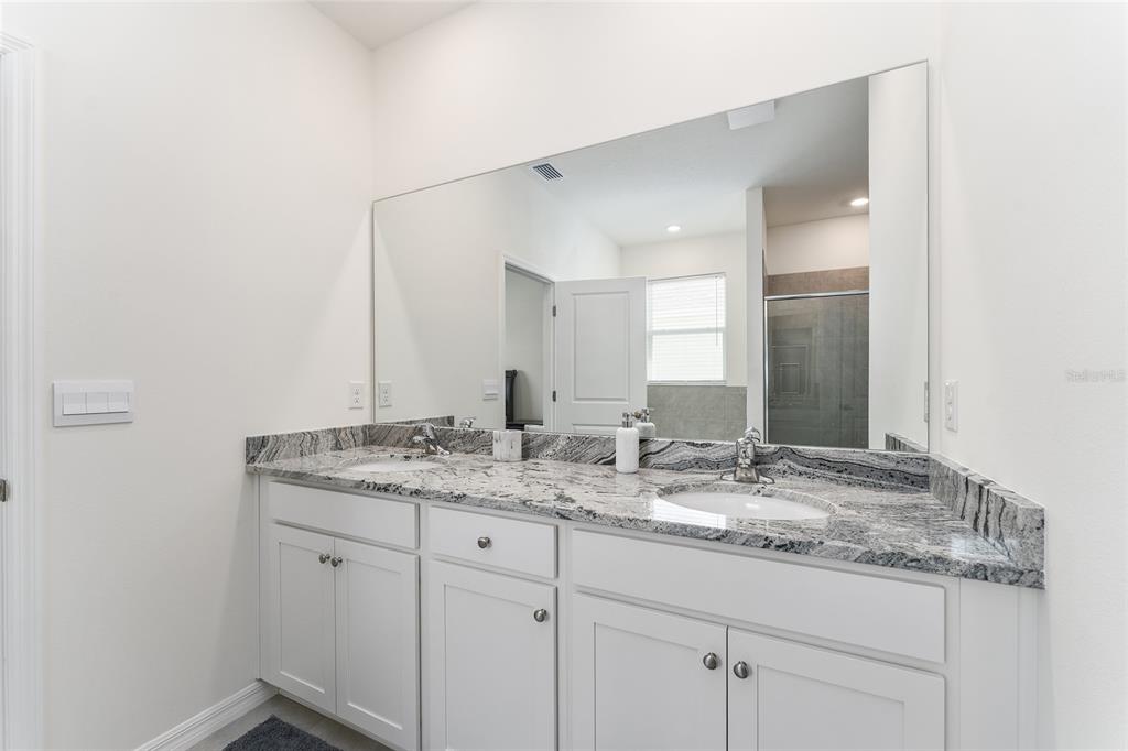 4098 Northwest 48th Terrace Ocala, FL 34482 - Photo 33 of 58 a bathroom with a granite countertop sink and a mirror