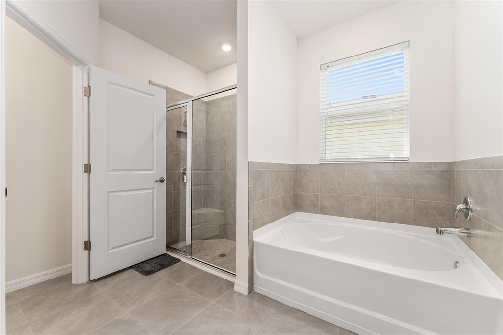 4098 Northwest 48th Terrace Ocala, FL 34482 - Photo 35 of 58 a bathroom with a bathtub and a shower
