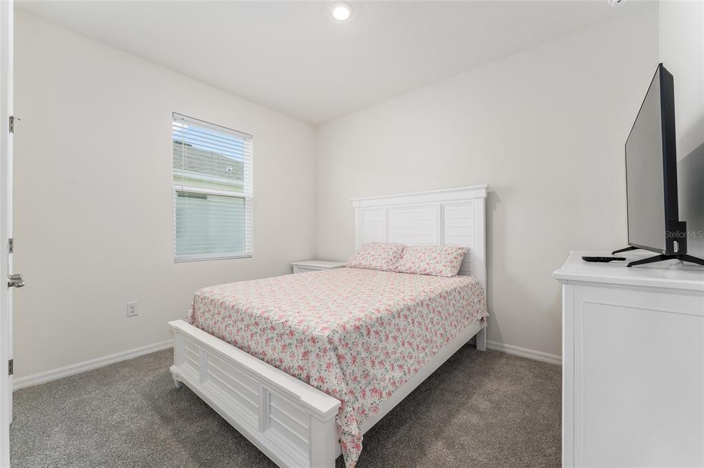 4098 Northwest 48th Terrace Ocala, FL 34482 - Photo 42 of 58 a bed sitting in a bedroom next to a window