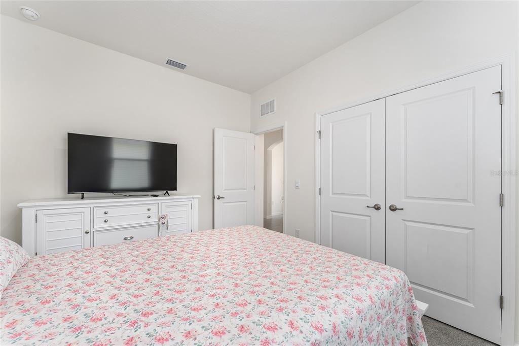 4098 Northwest 48th Terrace Ocala, FL 34482 - Photo 44 of 58 a bedroom with a bed and a flat screen tv