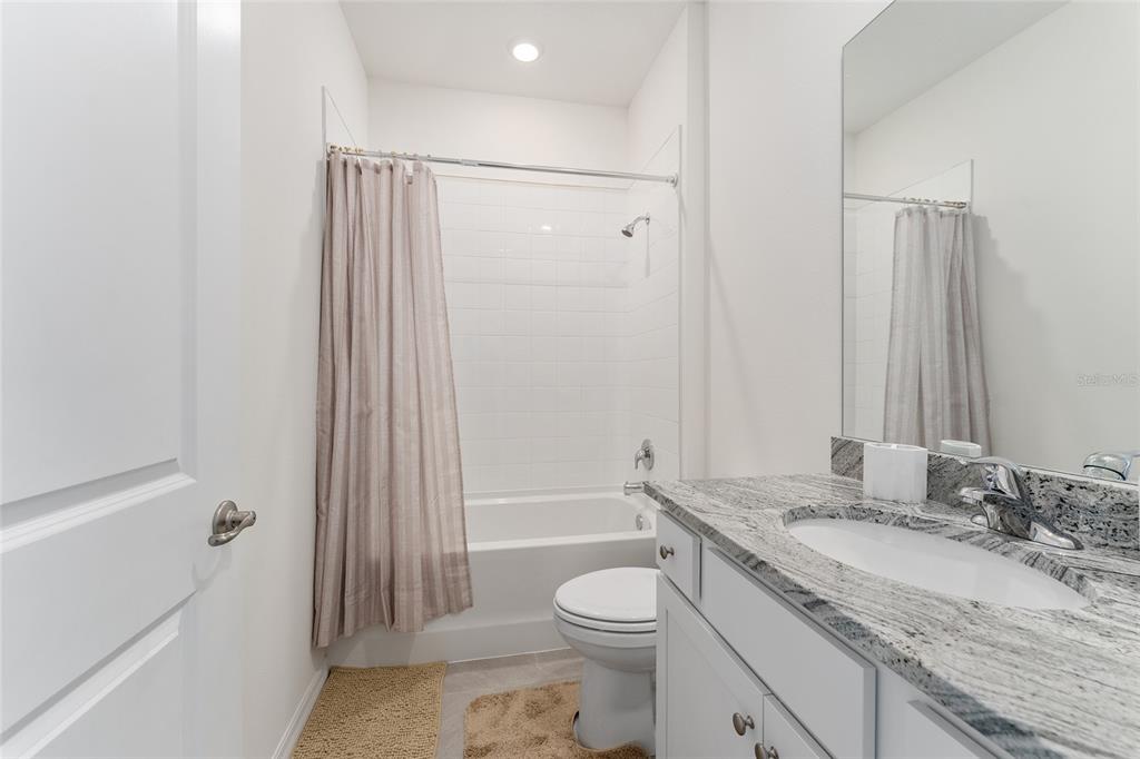 4098 Northwest 48th Terrace Ocala, FL 34482 - Photo 49 of 58 a bathroom with a granite countertop sink toilet and shower