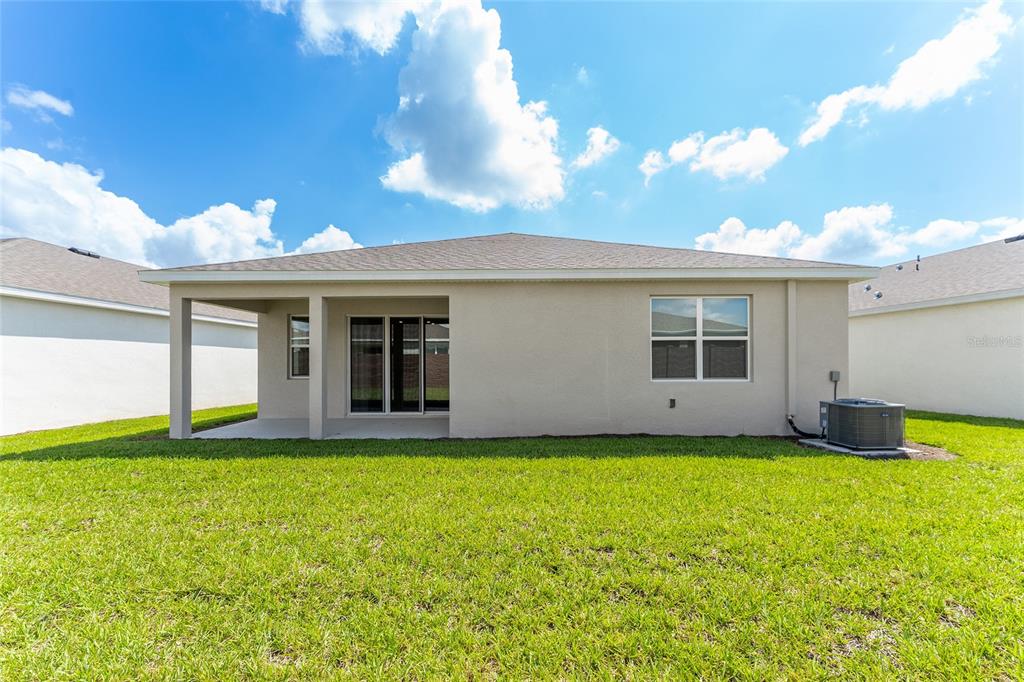 4098 Northwest 48th Terrace Ocala, FL 34482 - Photo 54 of 58 a view of a house with a yard and a large tree