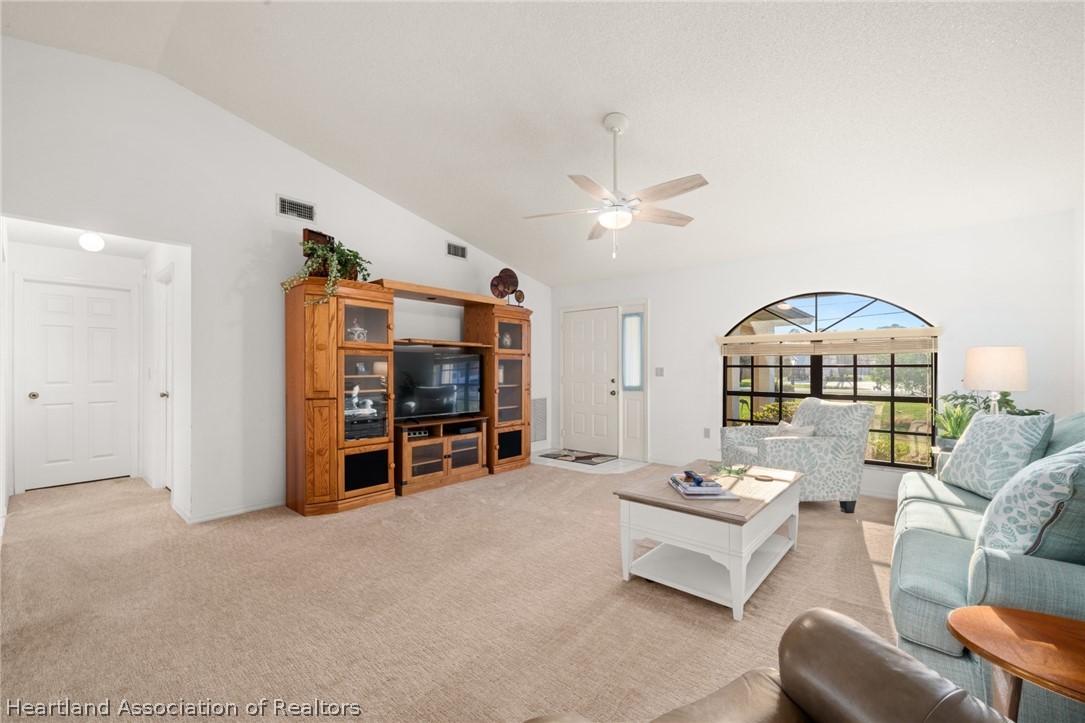 5802 Golden Road Sebring, FL 33875 - Photo 6 of 37 a living room with furniture and a chandelier