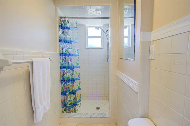 a view of entryway with window and ceiling fan