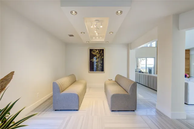 a living room with furniture potted plant and a rug