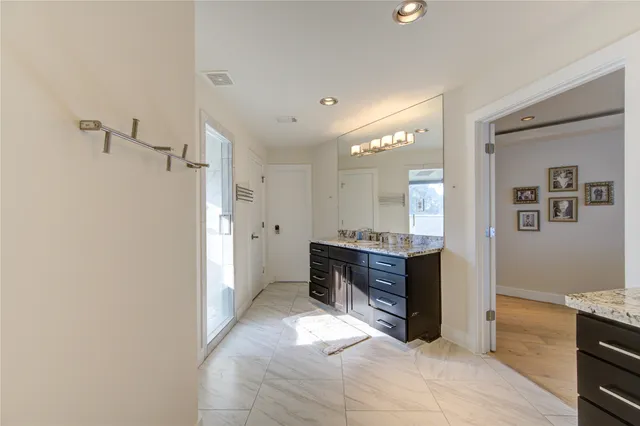 a bedroom with furniture and a large window