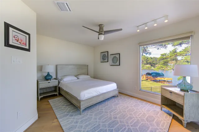 a living room with patio furniture and a floor to ceiling window