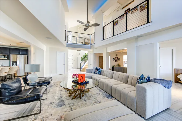 a living room with fireplace furniture and a large window