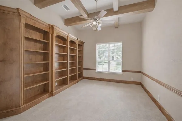a view of a livingroom with workspace and a window