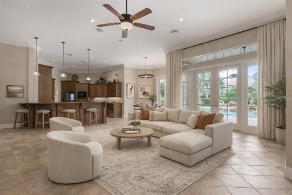 a view of a kitchen with a fireplace and a ceiling fan