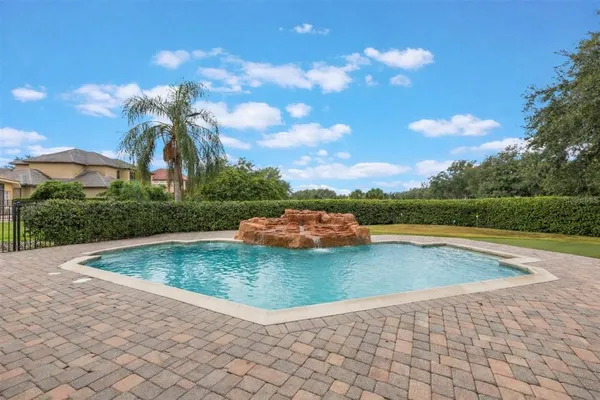 a view of a swimming pool with a yard