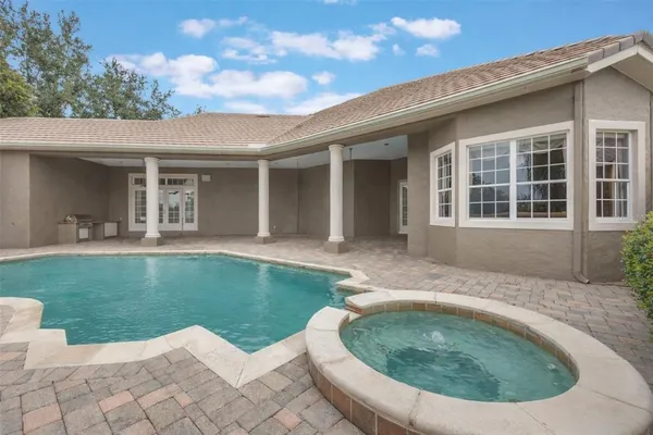 a view of a house with a backyard porch and sitting area