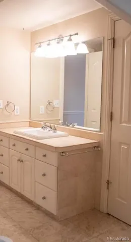 a bathroom with a granite countertop sink mirror and a bathtub