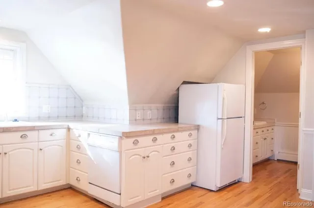 a kitchen with cabinets and white appliances