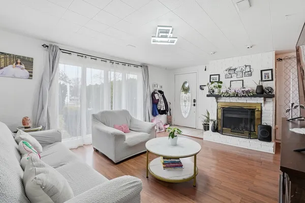 a living room with furniture and a fireplace
