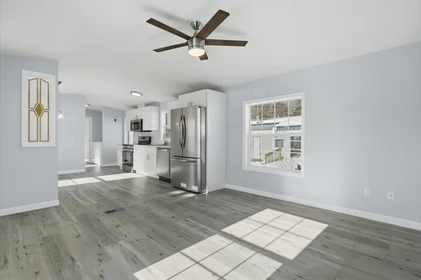 a view of kitchen with furniture and a ceiling fan