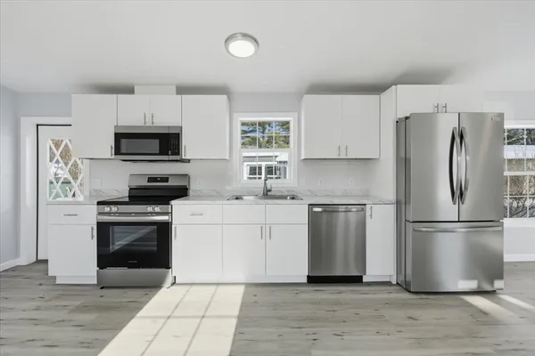 a kitchen with a refrigerator stove and microwave
