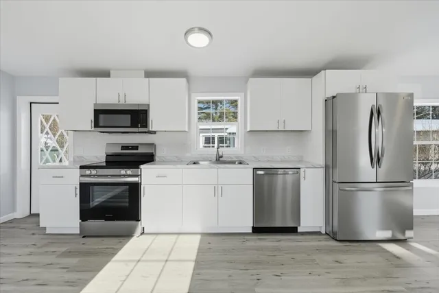 a kitchen with a refrigerator stove and microwave