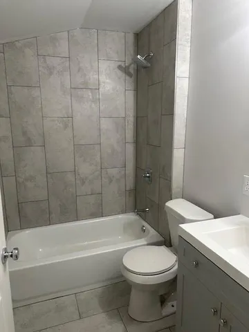 a bathroom with a toilet a sink and bathtub