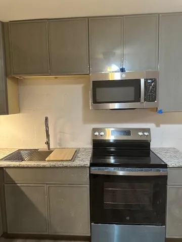 a stove top oven sitting inside of a kitchen
