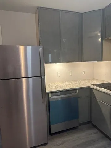 a kitchen with a sink and a refrigerator