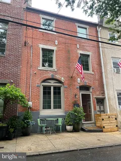 a view of a brick house with potted plants