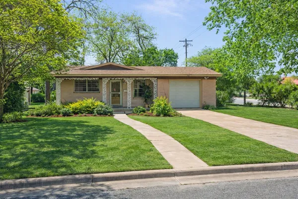 a front view of house with yard and green space