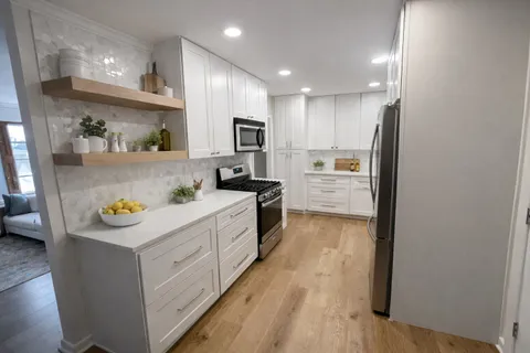 a kitchen with counter top space and stainless steel appliances