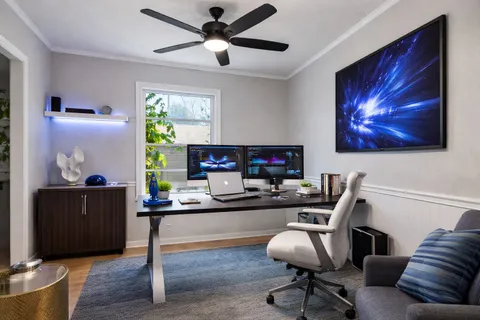 a work room with furniture and a flat screen tv
