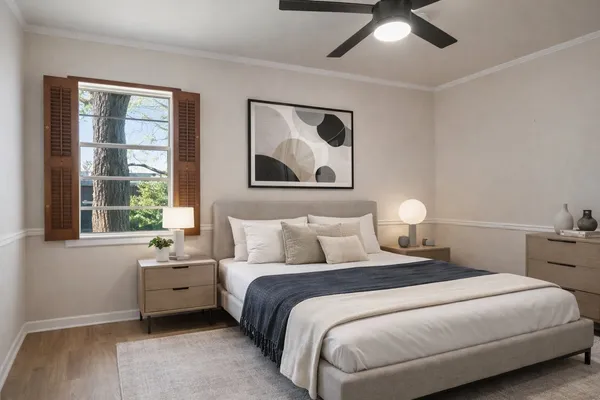 a bedroom with a large bed and a window