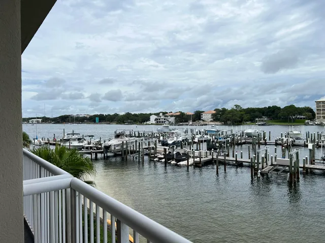 a view of a lake with boats and trees in the background