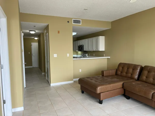 a living room with a couch and a dining table next to a window