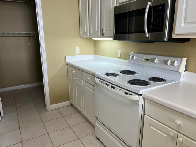 a kitchen with a cabinets and white appliances